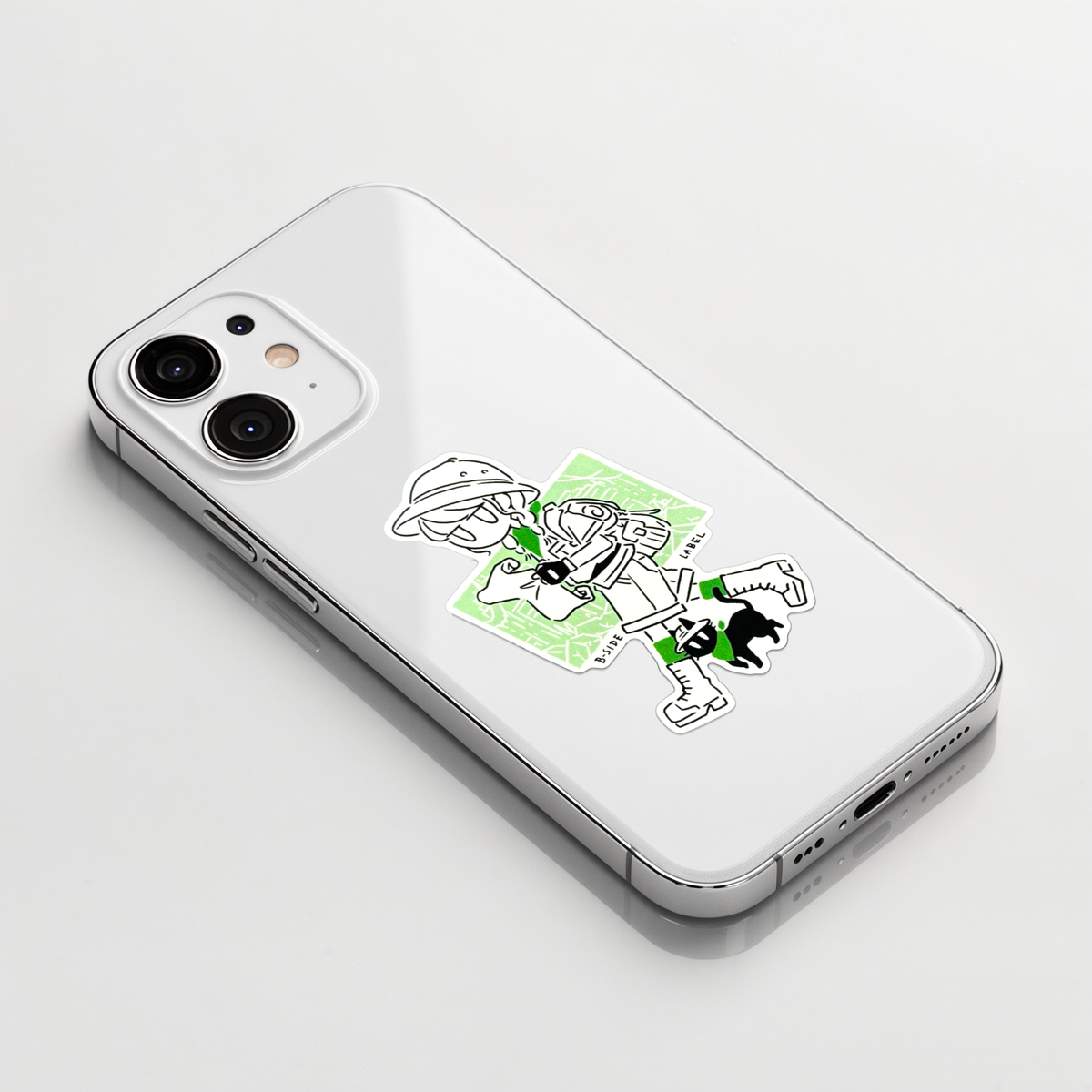 Girl & Kitten Explorers ✦ B-Side Label Sticker on a white iPhone