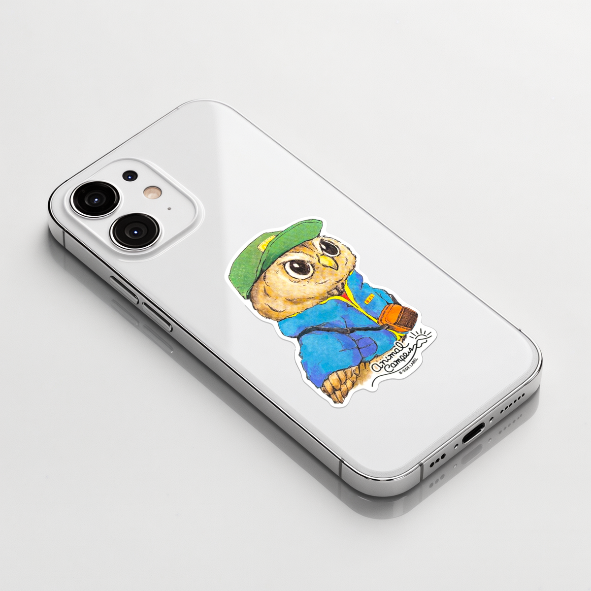 Cute Owl Camper ✦ B-Side Label Sticker on a white iPhone