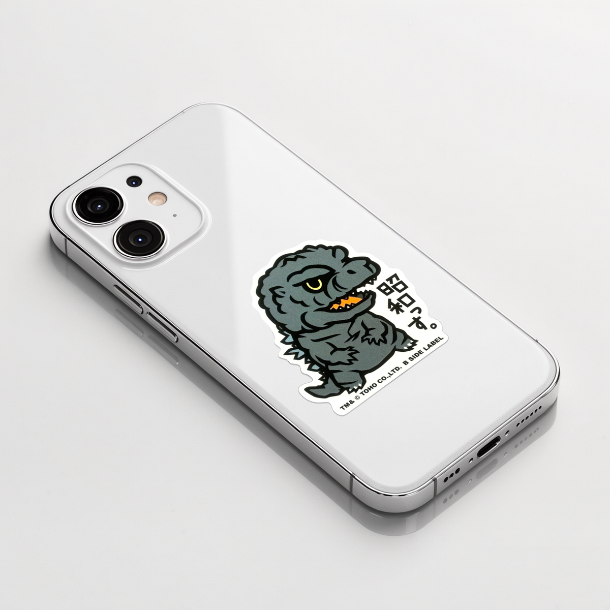 Godzilla Showa Era ✦ B-Side Label Sticker on a white iPhone