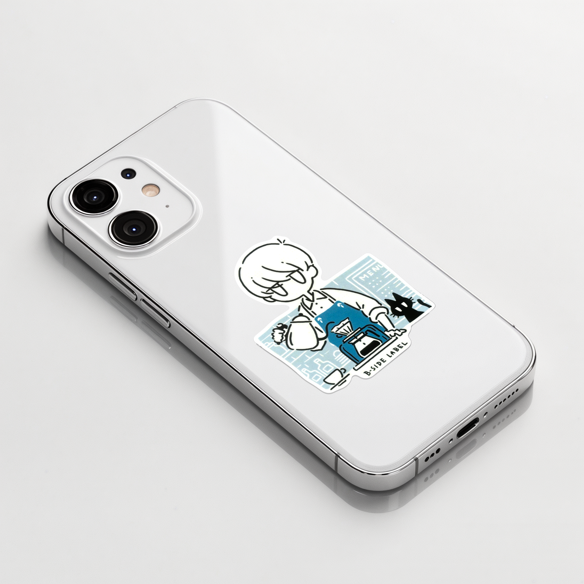 Coffee Barista & Cat ✦ B-Side Label Sticker on a white iPhone