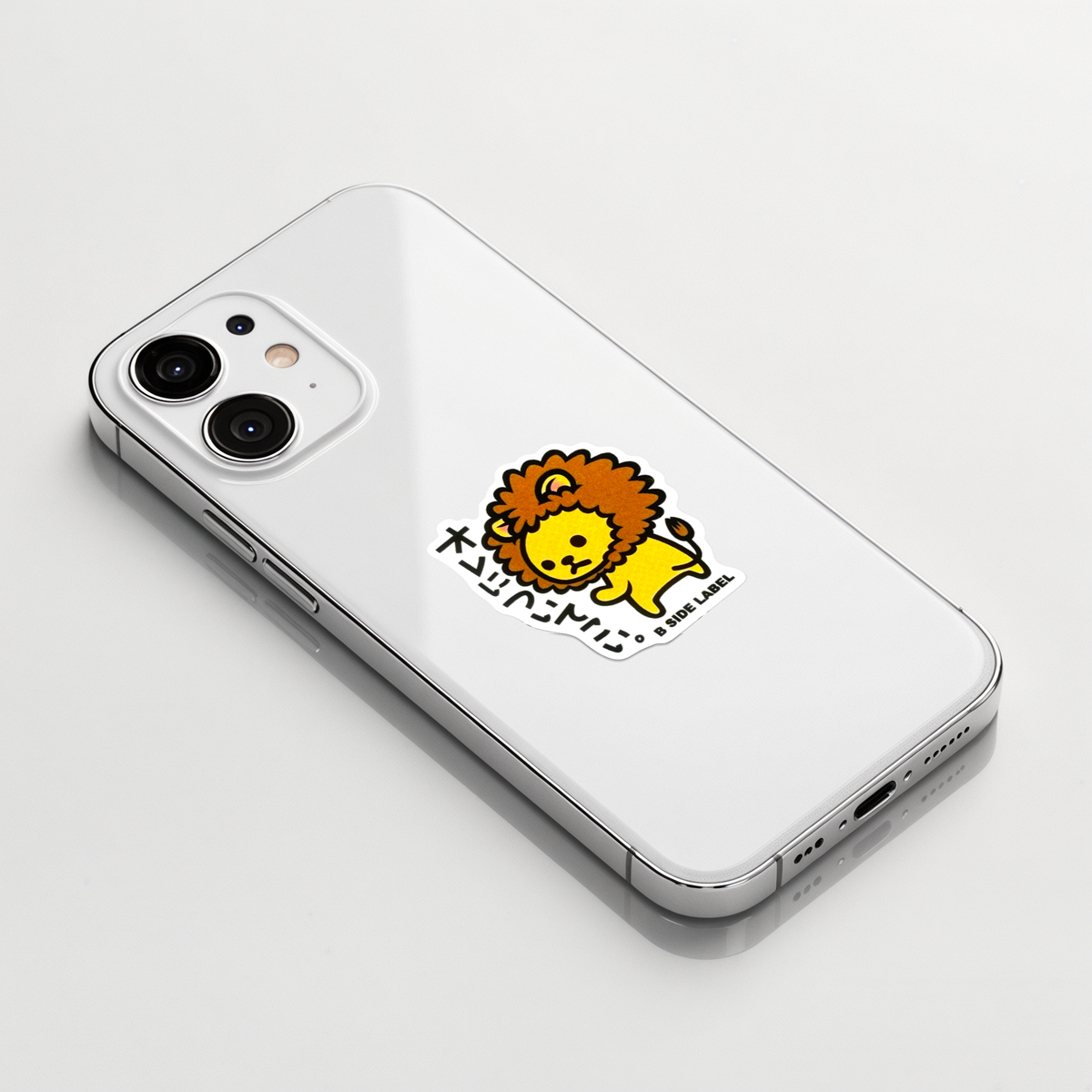 Cute Baby Lion ✦ B-Side Label Sticker on a white iPhone