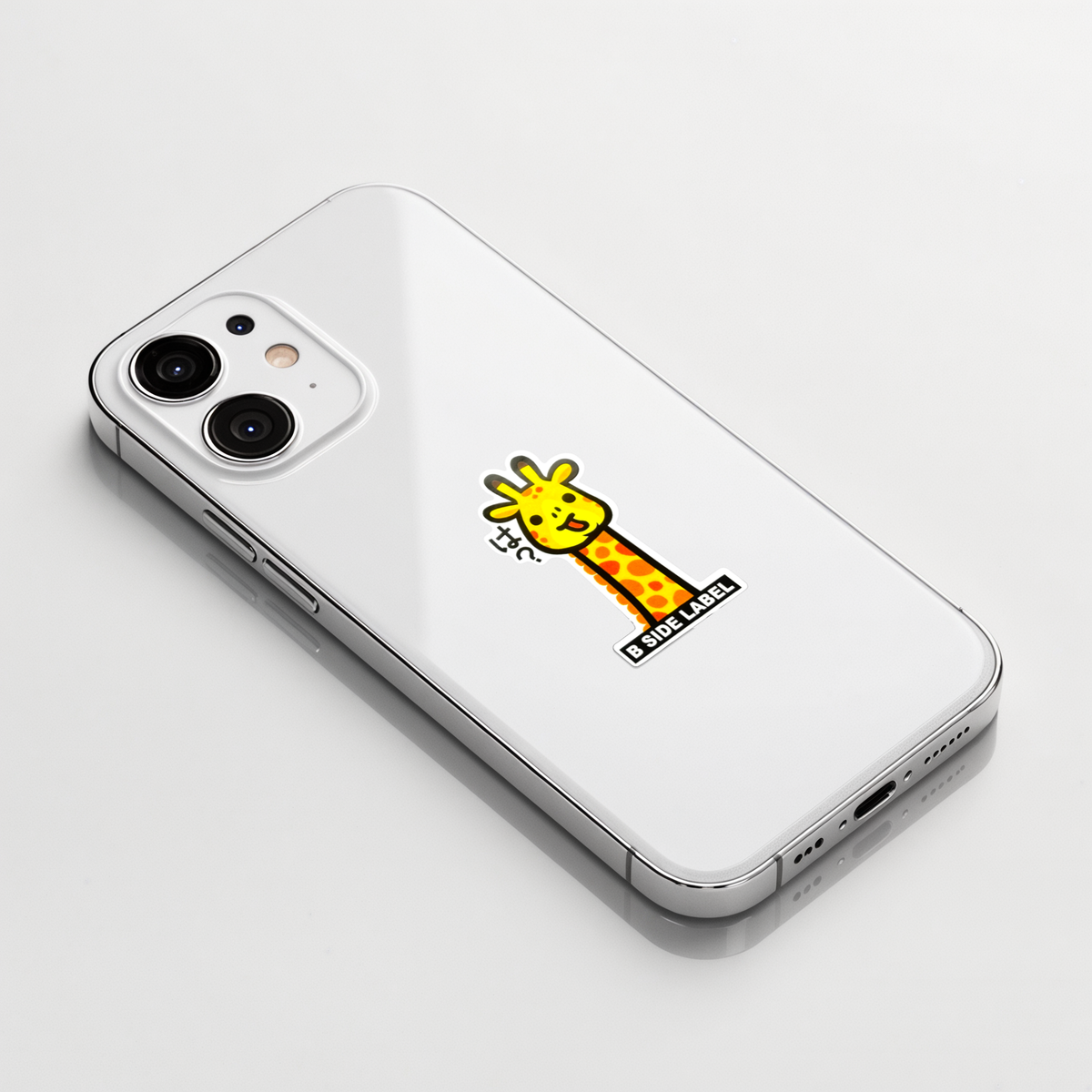 Cute Baby Giraffe ✦ B-Side Label Sticker on a white iPhone