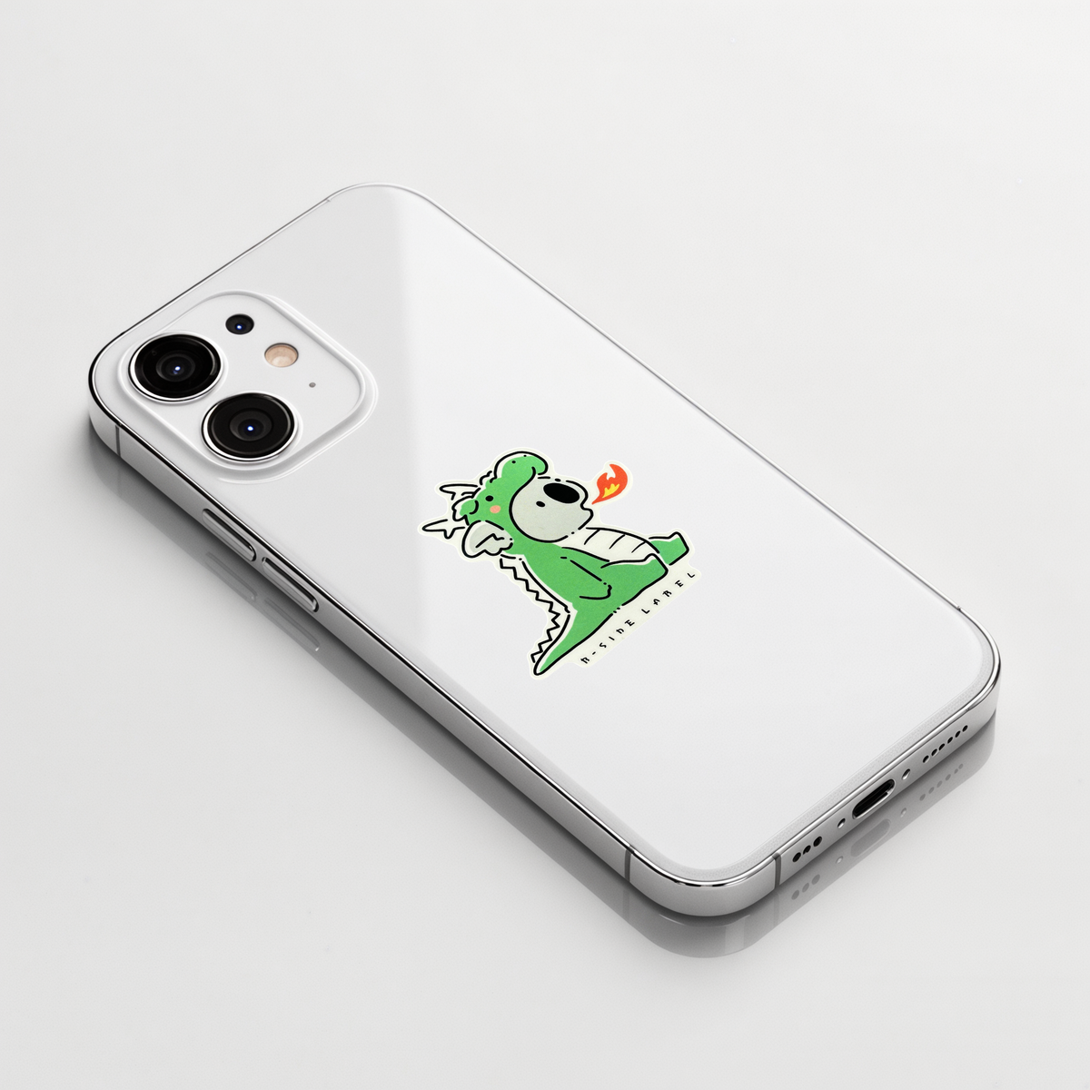 Cute Koala in Dragon Costume ✦ B-Side Label Sticker shown on a white iPhone; illustrative placement, not to scale.