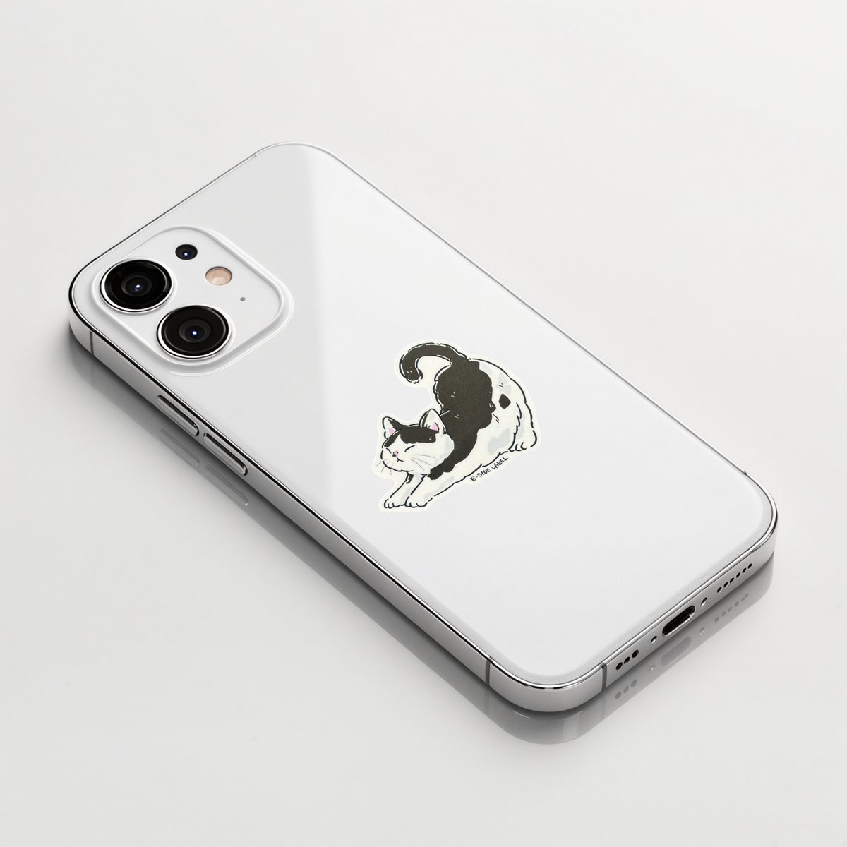 Black & White Cat Stretching ✦ B-Side Label Sticker shown on a white iPhone; illustrative placement, not to scale.