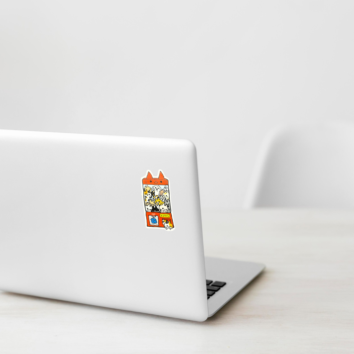 Cat Gatcha Machine sticker shown on a white laptop; illustrative placement, not to scale.