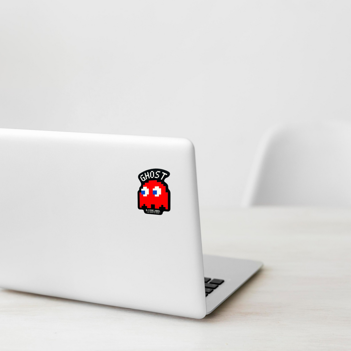 Pac Man Blinky ✦ B-Side Label Sticker on a white laptop — Shopify template, original photograph