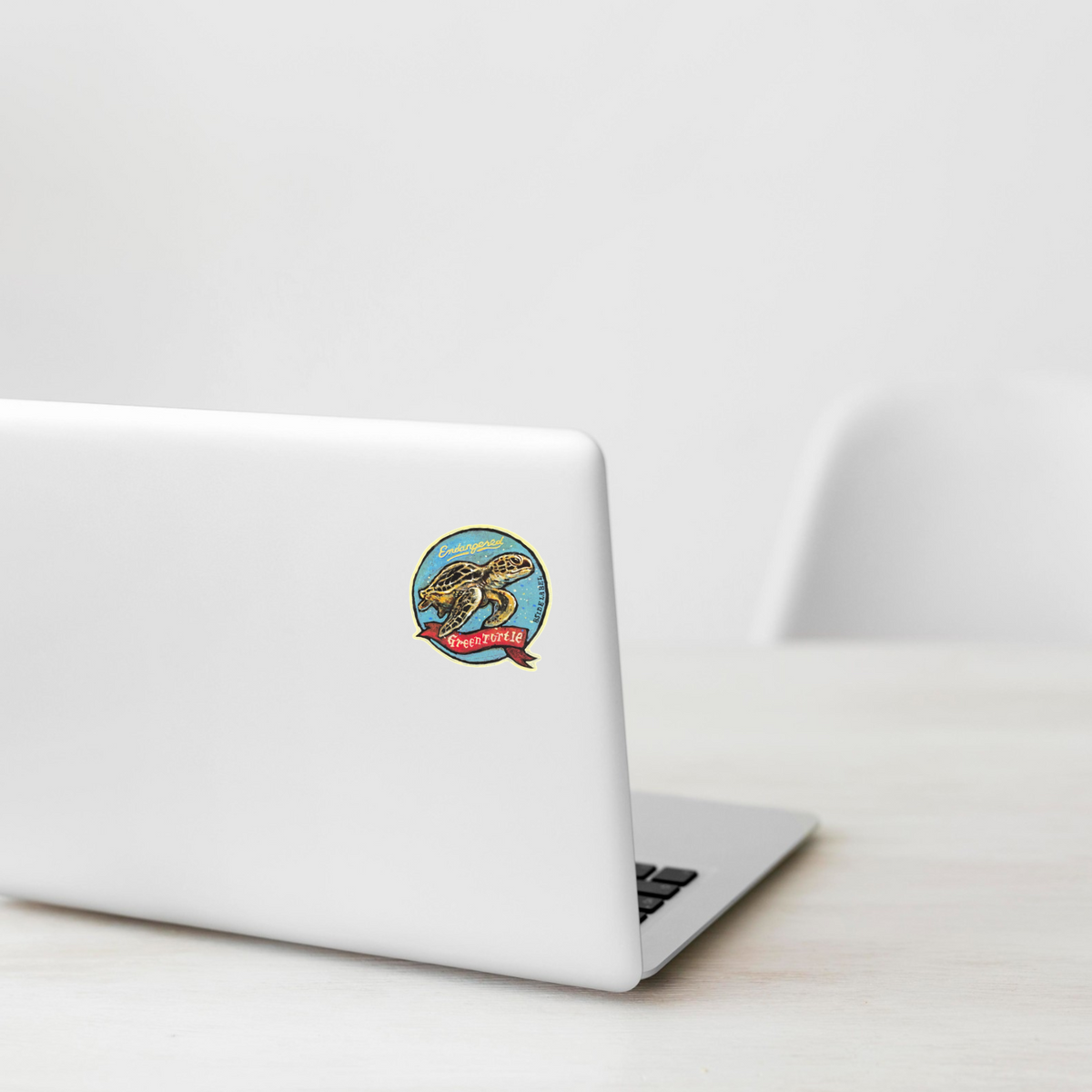 Endangered Green Turtle ✦ B-Side Label Sticker on a white laptop — Shopify template, original photograph