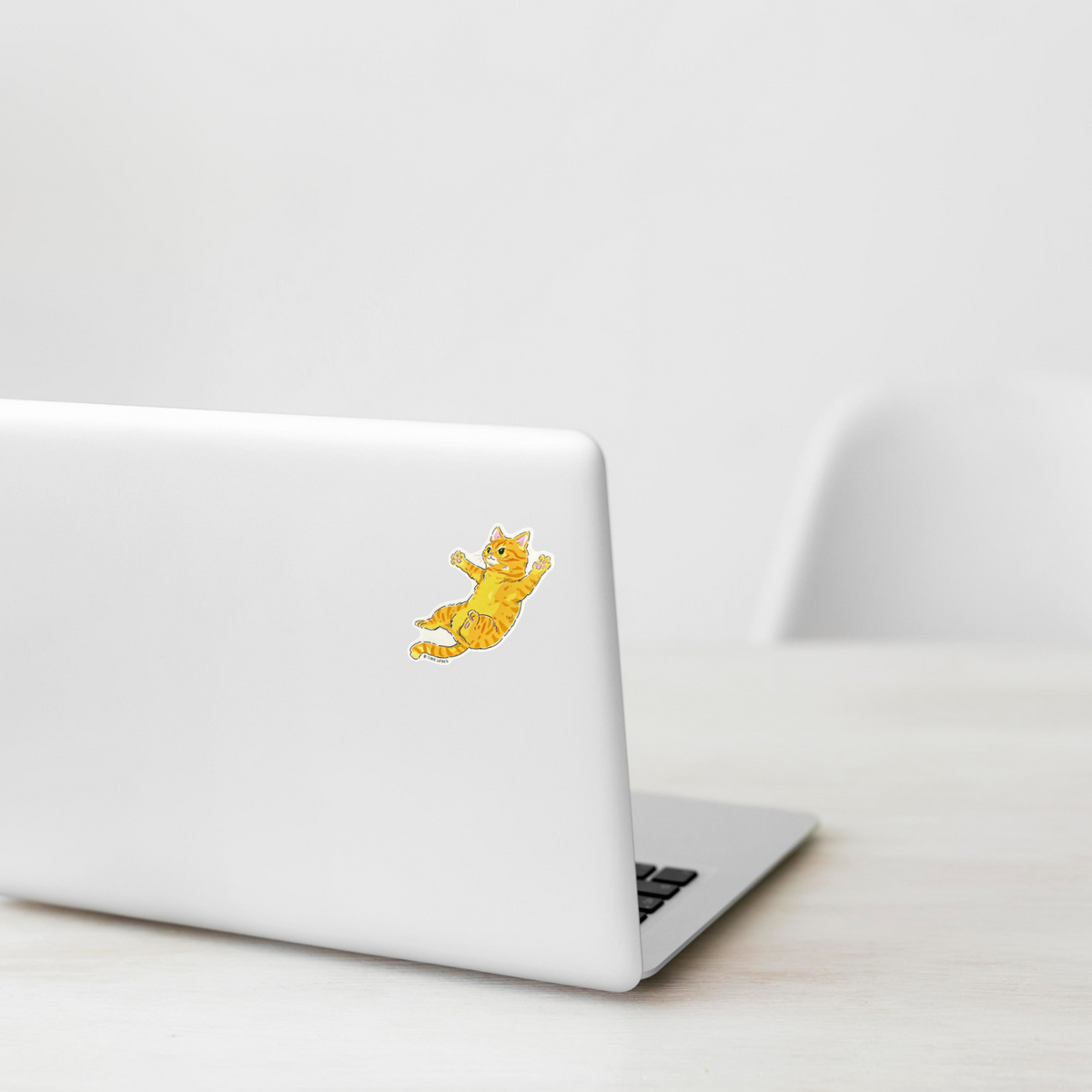 Cute Tabby Cat Jumping ✦ B-Side Label Sticker on a white laptop — Shopify template, original photograph