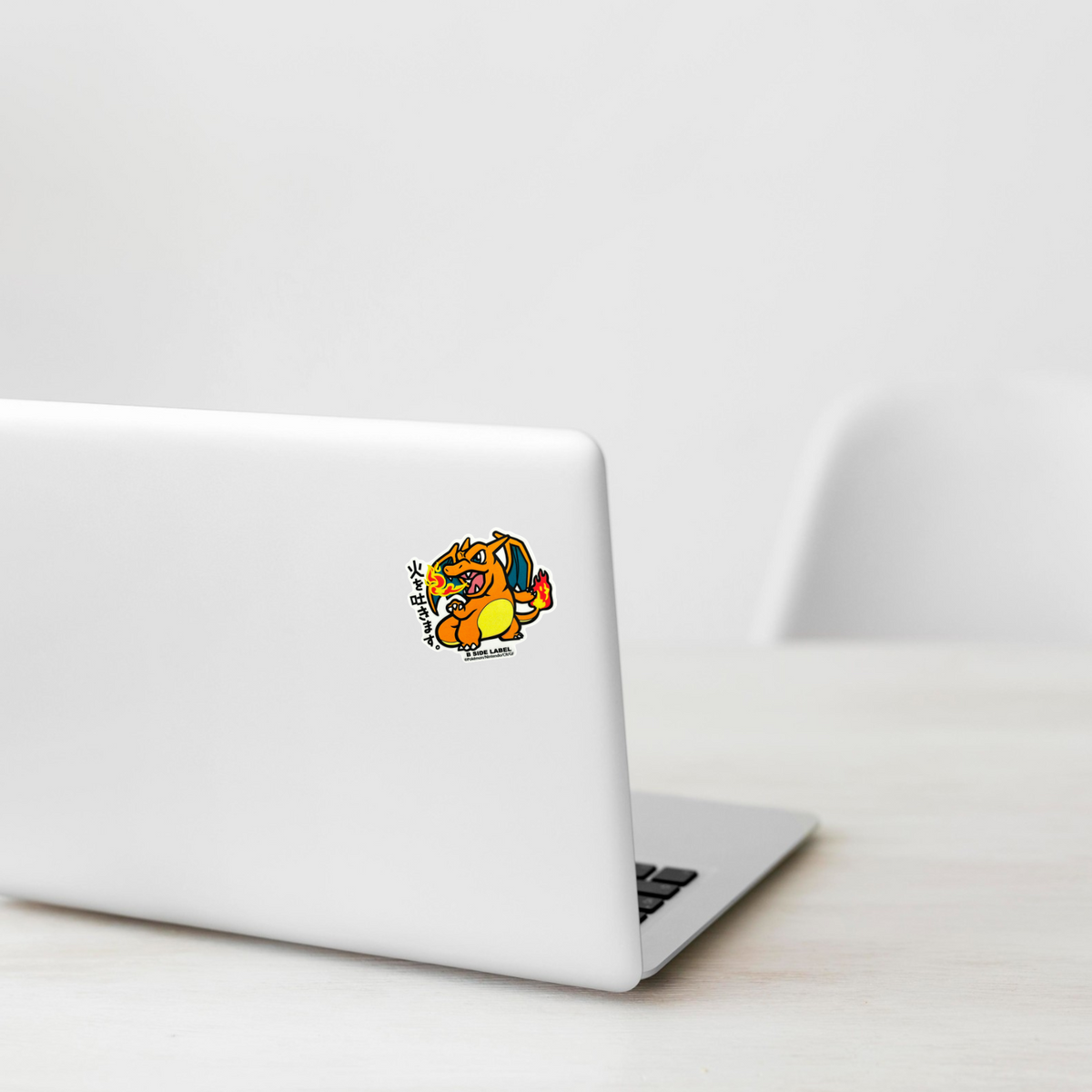 Pokémon Charizard ✦ B-Side Label Sticker on a white laptop — Shopify template, original photograph