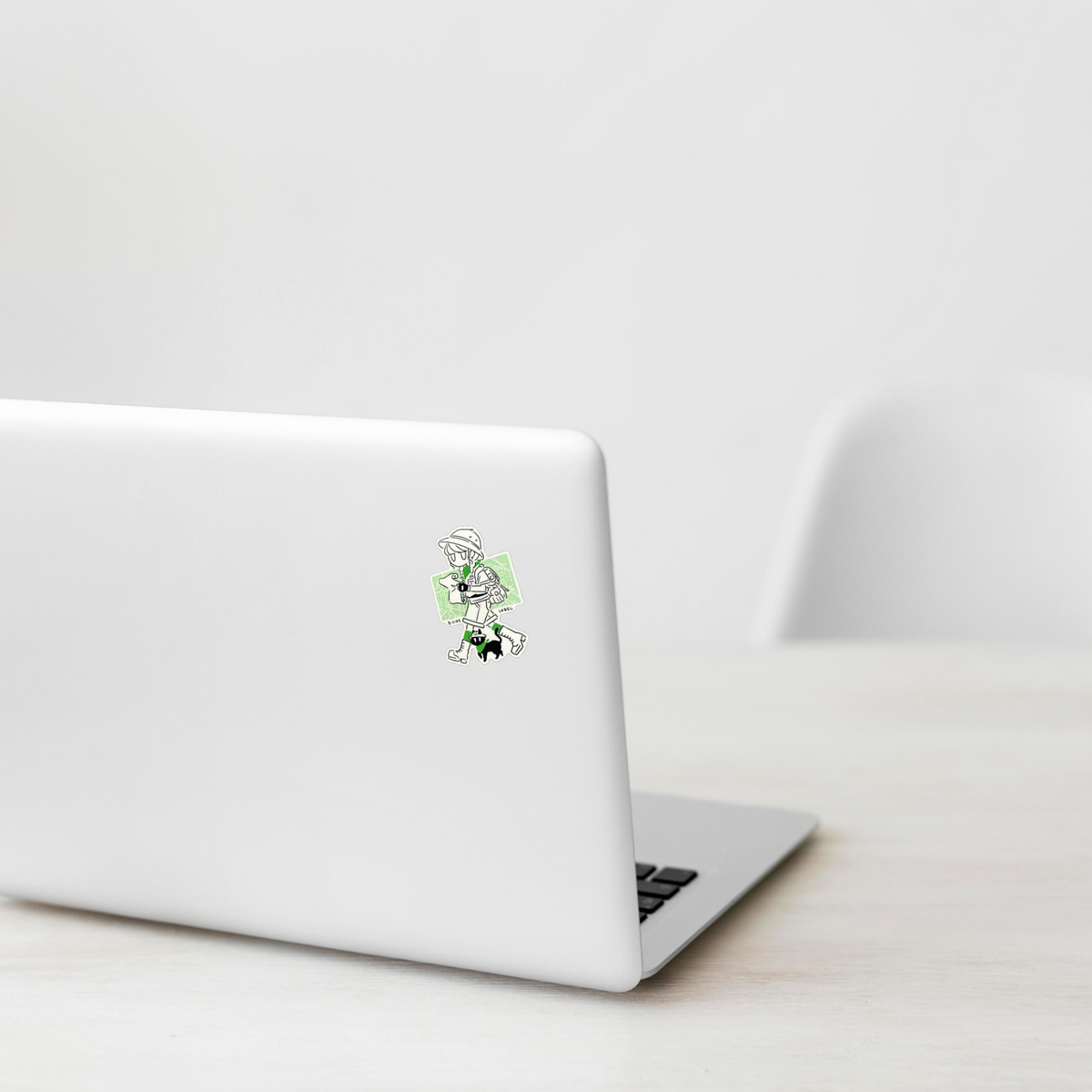 Girl & Kitten Explorers ✦ B-Side Label Sticker on a white laptop — Shopify template, original photograph